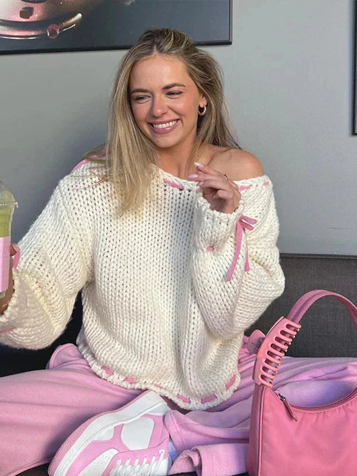 Sweter damski z dzianiny na jesień o asymetrycznym kroju z modnymi wiązaniami